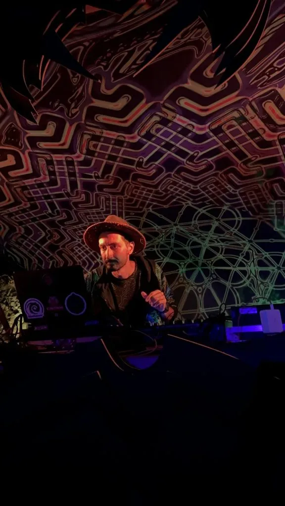 KOOROW performing beneath a psychedelic stage canopy